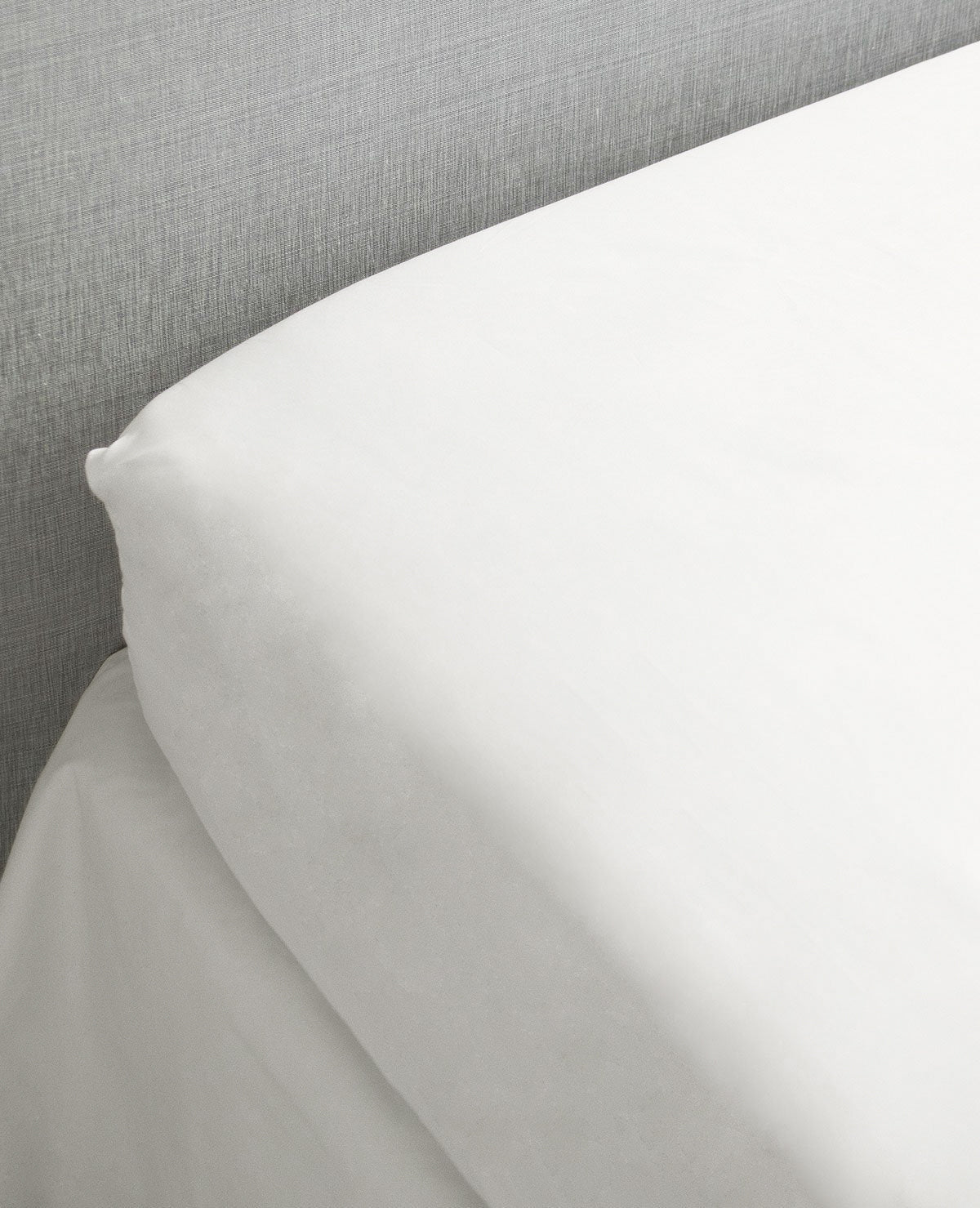 Milk cotton sateen fitted sheet stretched smoothly across a mattress