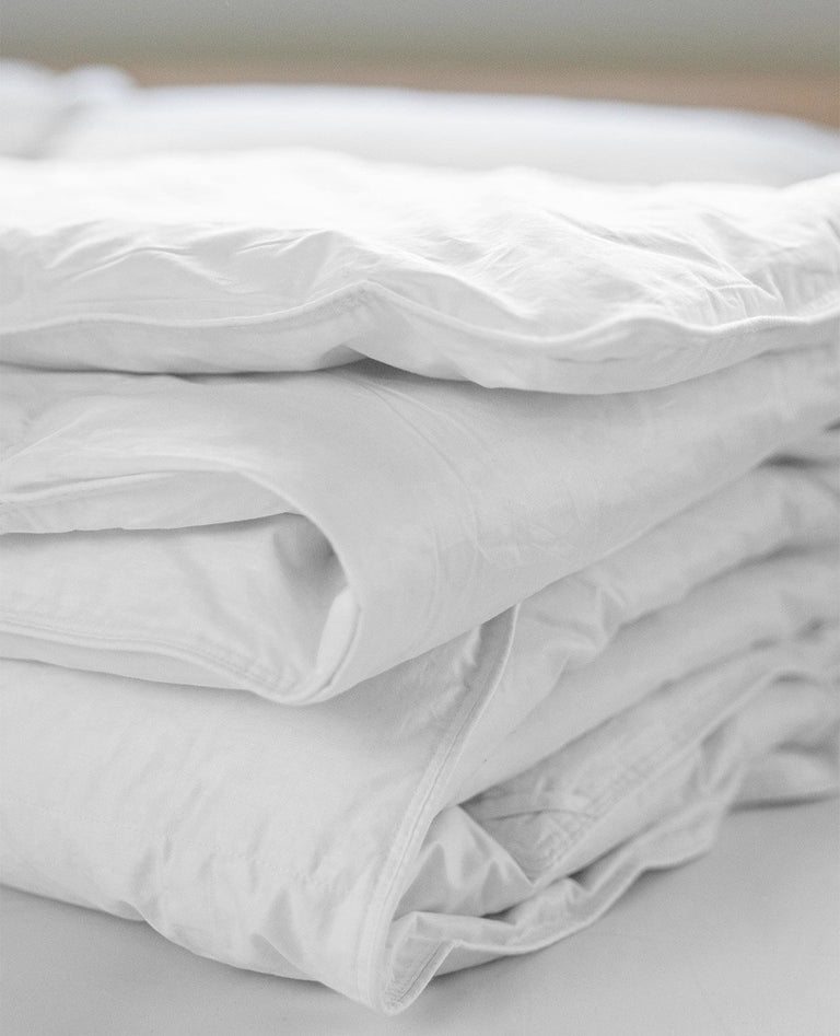 Folded white duvet showing soft texture and layered edges.